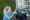 Professional caregiver offering respite care to elderly patient at home while family member takes a break