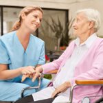 Caregiver and elderly client engaging in a warm handshake, symbolizing compassionate home care services and personalized support for seniors in Sarasota, Florida.