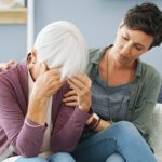 Caregiver comforting elderly woman in home care setting, emphasizing compassionate support for seniors at Lasting Legacy Healthcare Services.