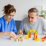 Caregiver and senior engaging in mental stimulation activities, emphasizing personalized dementia care and companionship at Lasting Legacy Healthcare Services.