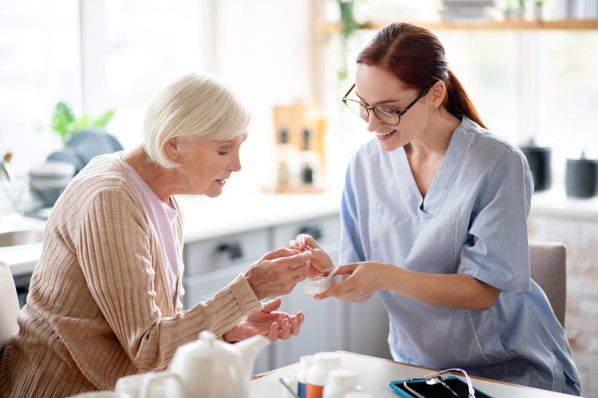 Caregiver providing compassionate in-home support to an elderly client, emphasizing personalized care and emotional well-being.