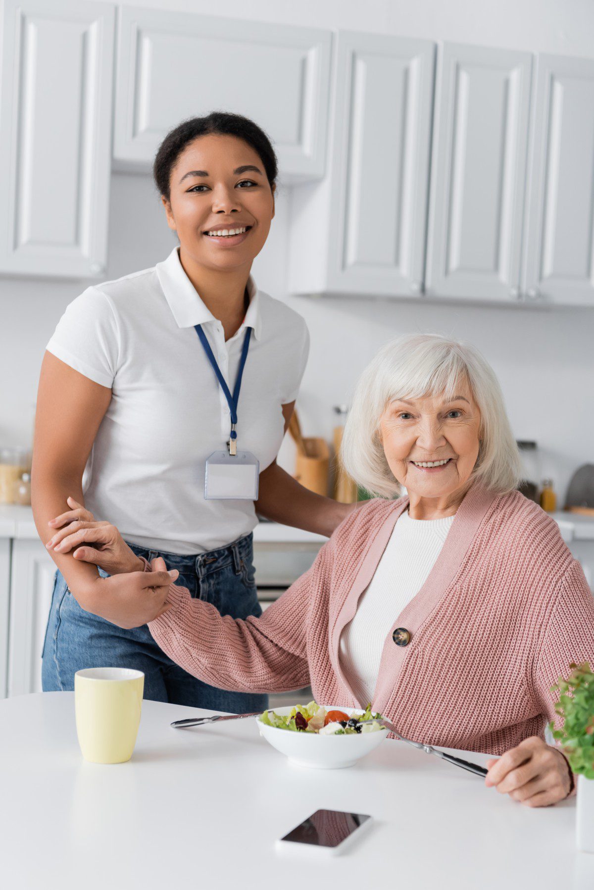 Caregiver assisting senior client with personalized support and companionship in a home setting, reflecting Lasting Legacy Healthcare Services' commitment to quality in-home care.