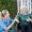 Professional caregiver offering respite care to elderly patient at home while family member takes a break